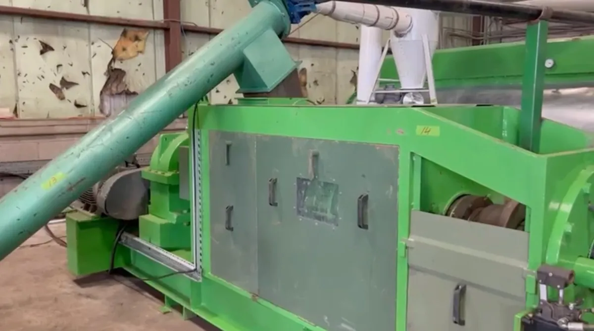 A green processing unit fed by an inclined screw conveyor